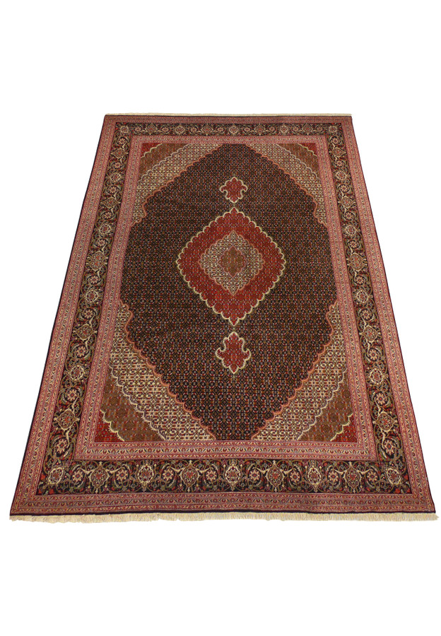 6'6 x 10'3 Persian Tabriz Mahi rug laid down showcasing detailed patterns and craftsmanship.