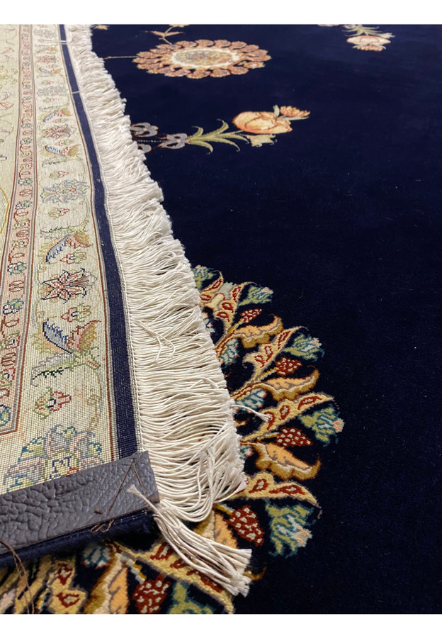 Detail view of the 10x13 Persian Tabriz Silk rug's border pattern with vibrant floral motifs.