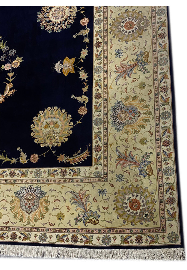 Detailed view of another floral border in a 10x13 Persian Tabriz rug