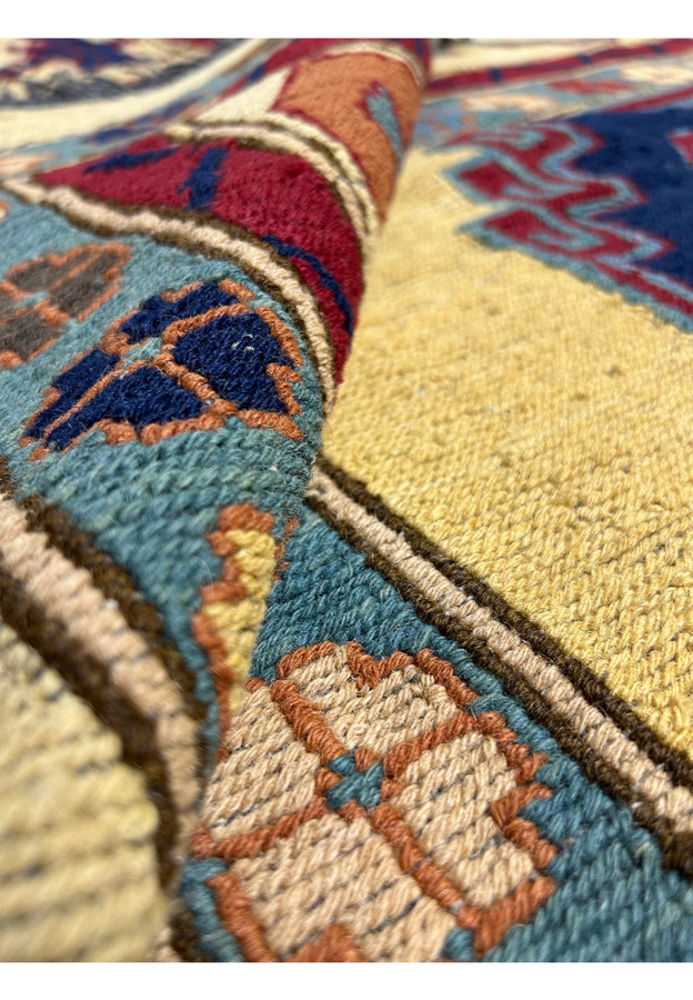 Rolled view of 13'3 x 16'2 Tribal Afghan Rug showcasing detailed hand-knotted craftsmanship and rich color contrasts.