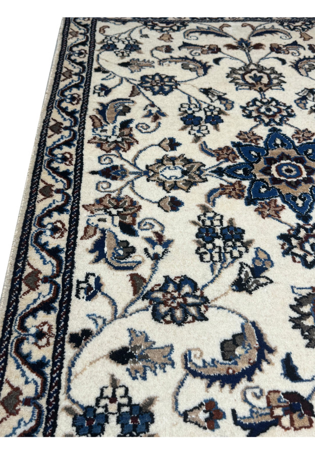Side view of 3 x 4'4 Persian Nain Rug highlighting the detailed floral design and rich color contrasts on an ivory background.