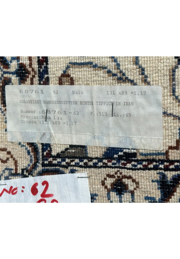 Tag on the backside of 3 x 4'4 Persian Nain Rug indicating its authenticity and origin.