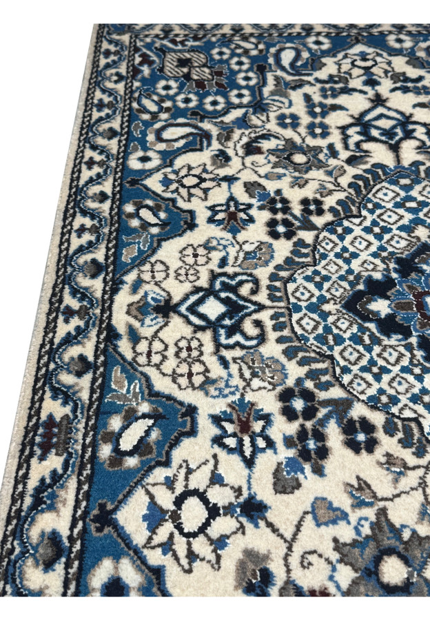 Side view of the 2'9 x 4'7 Persian Nain Rug highlighting its thickness and wool texture.