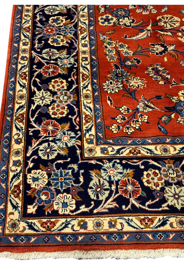 Detailed view of the floral motifs on the 6'6 x 10'2 Persian Sarough Rug with a rich burnt orange background.