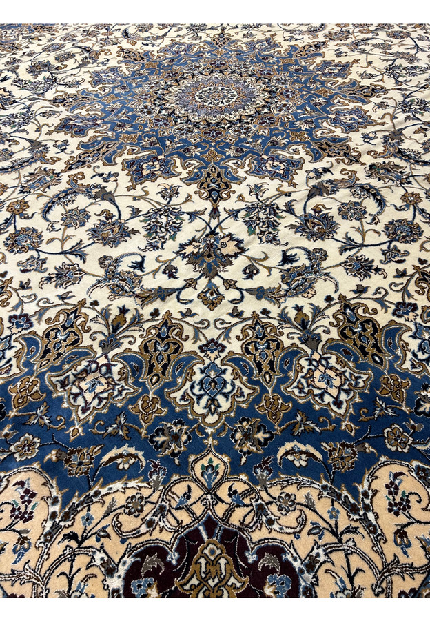 Midfield design of the 16' x 16' Persian Nain rug with navy blue and ivory floral patterns.