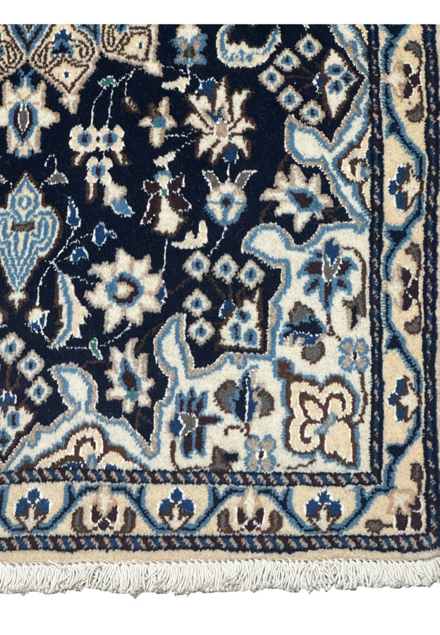 Detailed border of 2'8 x 4'6 Persian Nain Rug with repeating floral motifs in ivory, blue, and brown.