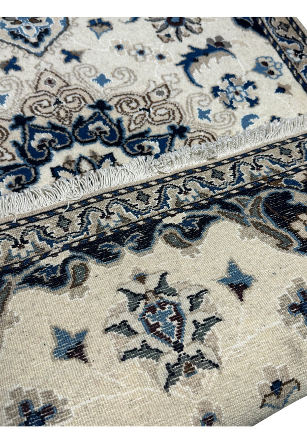 Backside of the Nain Persian rug displaying the handwoven cotton foundation and craftsmanship details.