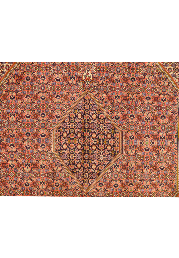 Close-up of central medallion with symmetrical Persian design in navy, red, and ivory tones.