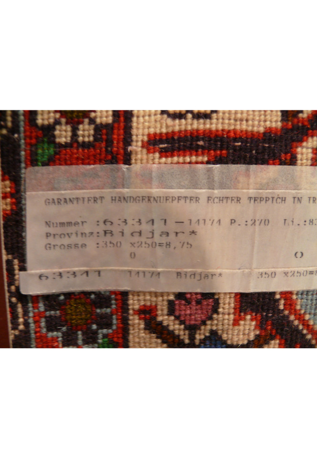 Original label reading “Bidjar” with hand-written size confirming hand-knotted Persian origin on back of rug.