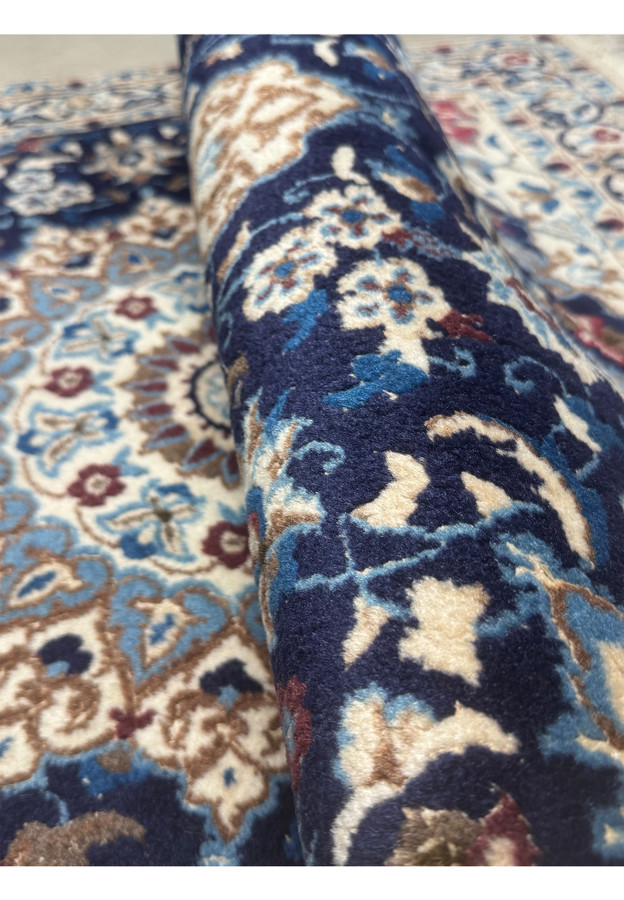 Rolled view highlighting fine weave and wool-silk texture