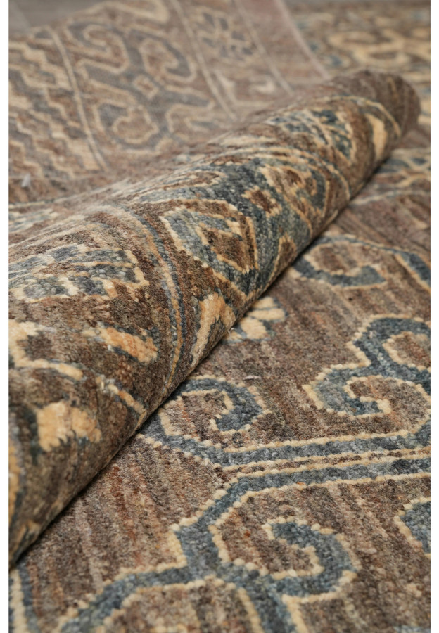 Zigler Transitional Rug rolled corner highlighting wool pile, earthy brown and grey tones with beige accents.