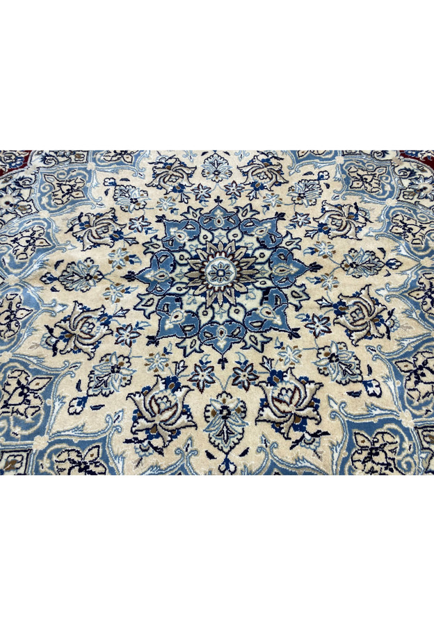 Intricate ivory and blue floral medallion design on red Persian Nain 9 LAA wool and silk rug