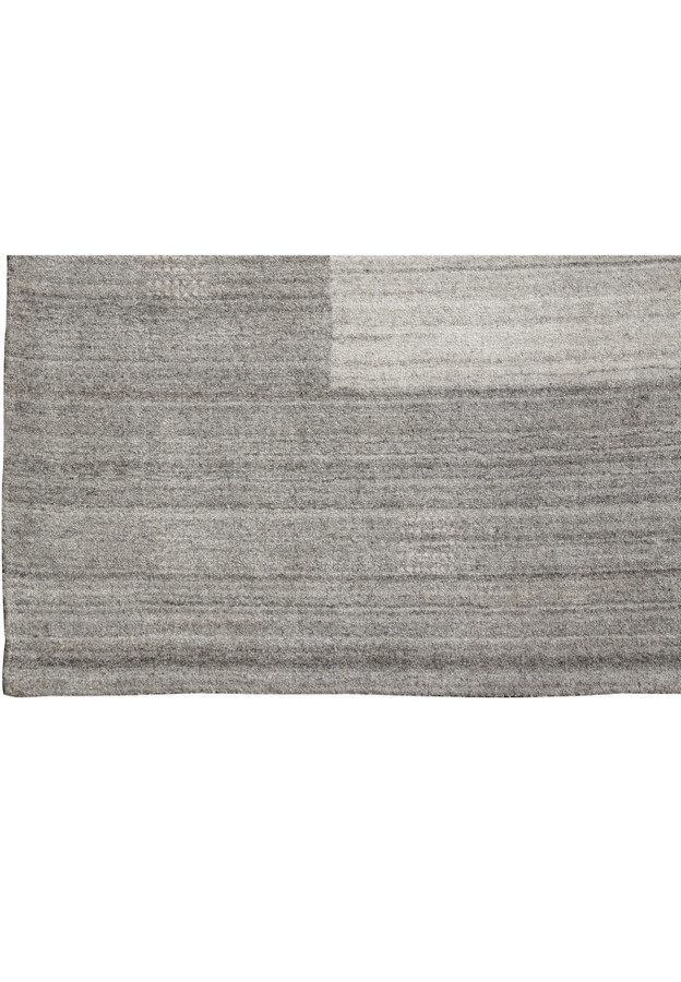Close up of border on 9.2 x 12.1 gray wool handmade rug showing tonal gray transition