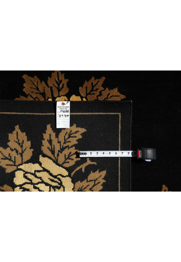 Backside of 7'9 x 10 handmade modern floral wool rug showing fine weave and label