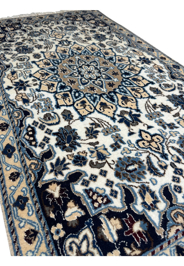 Angled view of 2'9 x 4'10" Ivory Nain Persian Rug showing pile and design depth.