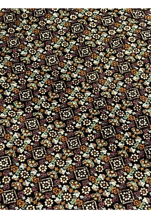 Close-up of the iconic Mahi fish motif repeated in the field of Tabriz rug