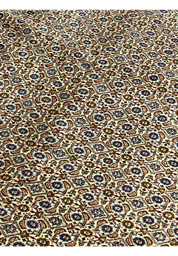 Midfield of Persian Moud rug showing repeating Herati motifs in ivory and navy