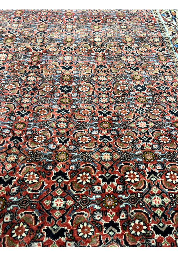 full pattern focus showing repeating Herati design in rust and navy tones