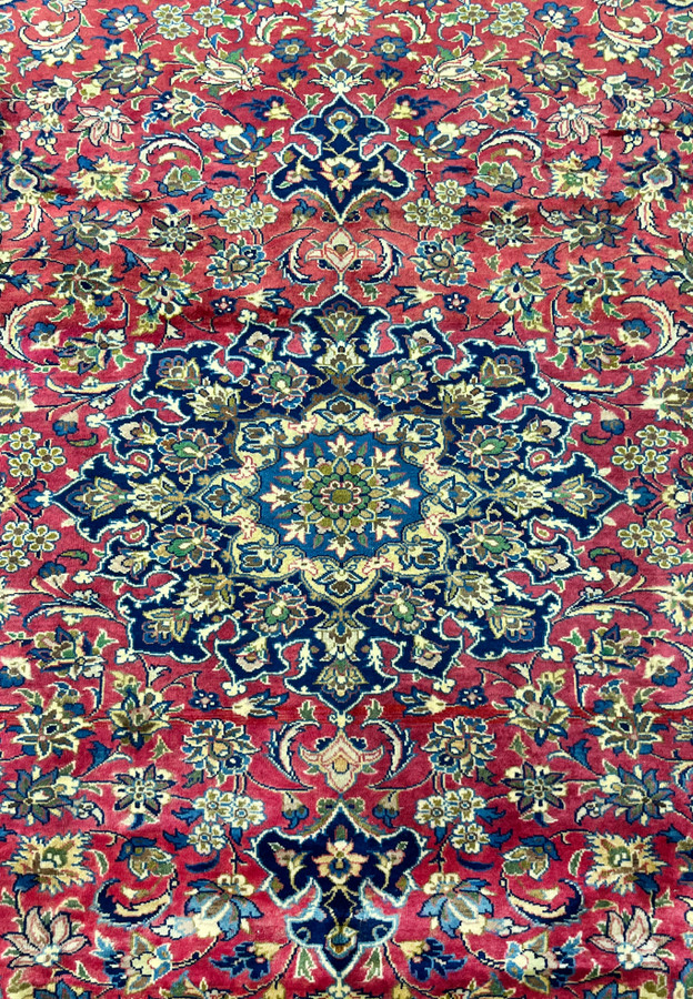 Macro close-up of the Persian Isfahan medallion, showing intricate floral and curvilinear knot work.