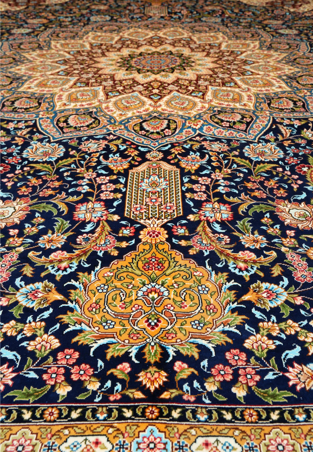 Detailed midfield view showing intricate silk weaving and floral motifs in navy, burgundy, and ivory tones.