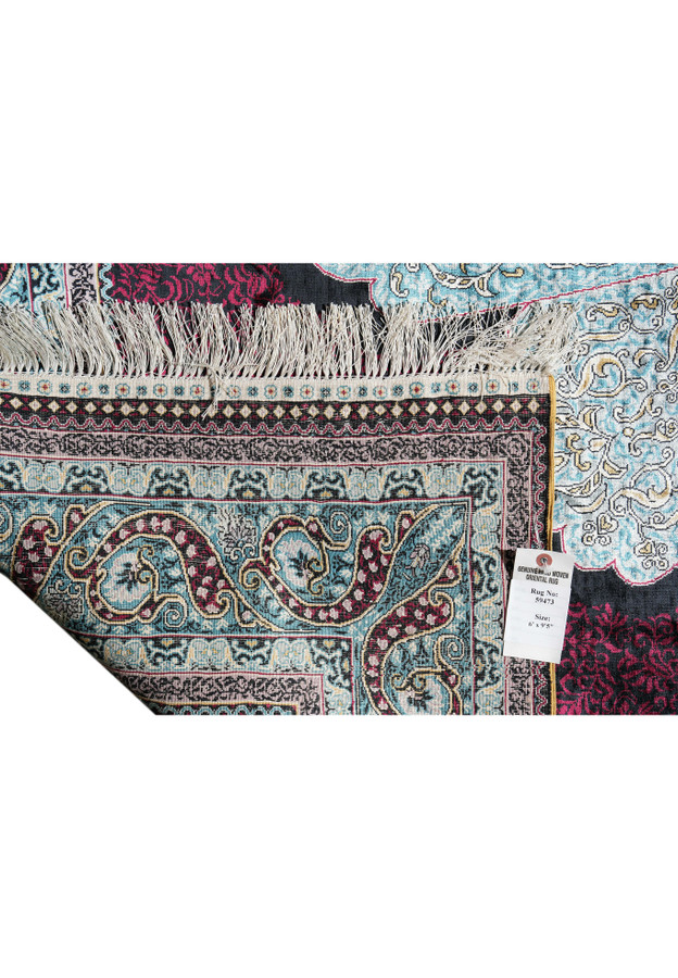Backside of Chinese silk oriental rug showing knot density, fringes, and tag marked 6x9’5 size