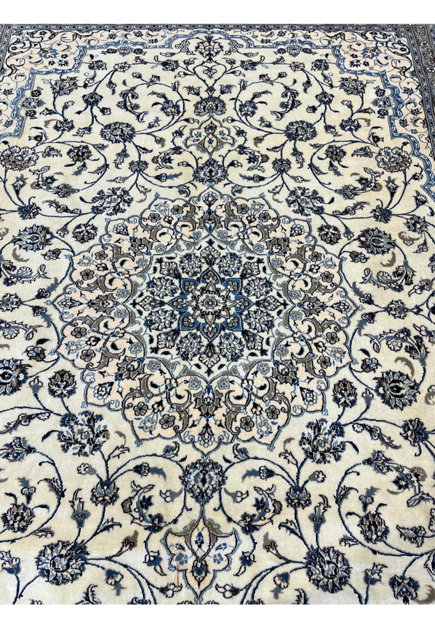 Central medallion of 10' x 13'2 Persian Nain 9LA Rug showing layered floral rosettes and symmetrical blue design.