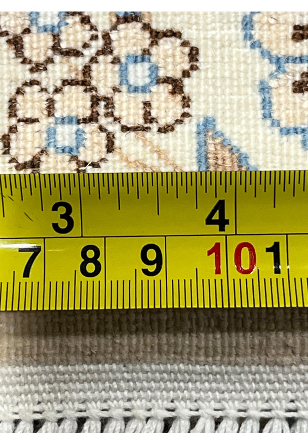 Measuring ruler on backside of Persian Nain 6 LA rug showing tight knot count per inch, ivory foundation, and authentic hand-woven Persian craftsmanship.