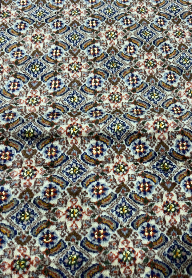 Detailed Herati fish pattern with blue rosettes and olive-green leaves on ivory field of Moud rug.