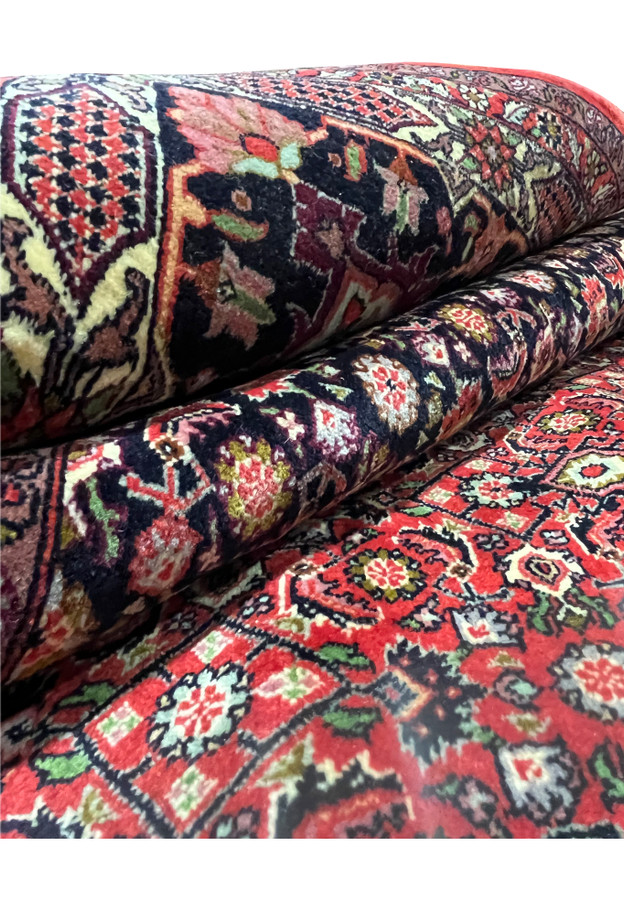 border of 10x13 Bijar Persian rug showing navy background with golden floral vines