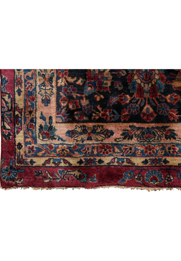 Close-up of original uneven fringes on antique Persian Kashan rug with soft wool pile and detailed floral corner border.