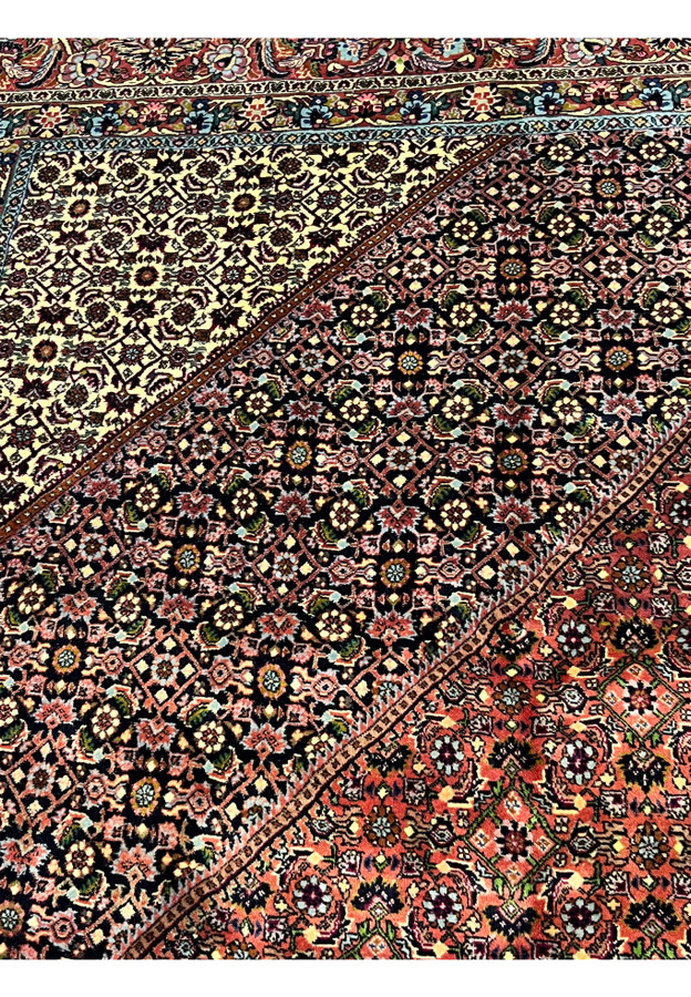 Detailed section of Bijar rug’s medallion and surrounding lattice with ivory, red, and navy motifs.