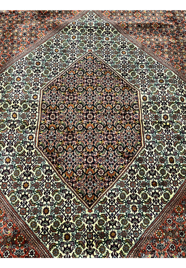 Close-up of cream and dark navy medallion details on the Bijar Persian Iron Rug.