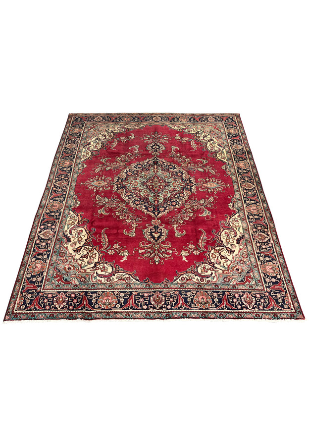 Top view of the Patina Vintage Persian Tabriz Rug highlighting the aged red field, floral medallion, and cream corner spandrels.