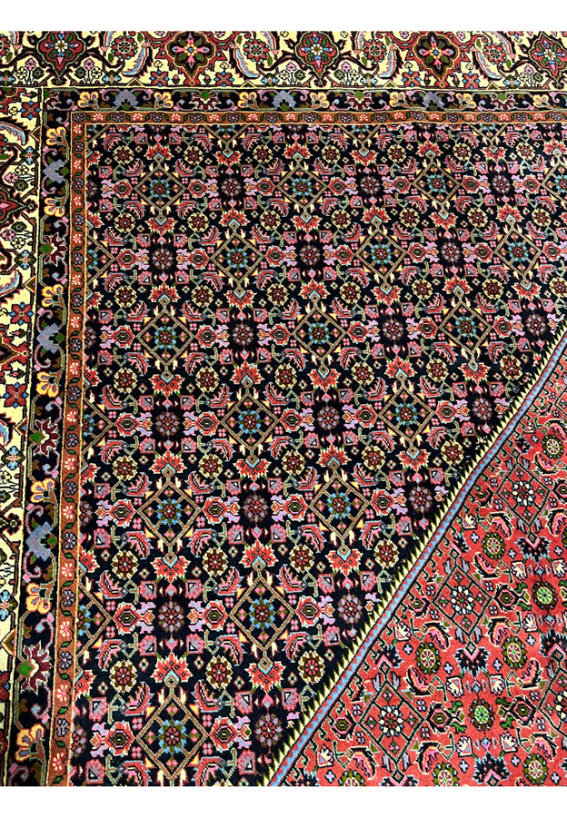 Inner border detail of rare size Persian Bijar iron rug showing layered floral framing and dense geometric vine pattern