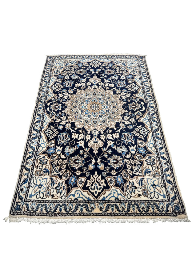 Top view of 3x5 Persian Nain rug showing navy blue background, ivory corner spandrels, and light blue floral scrollwork