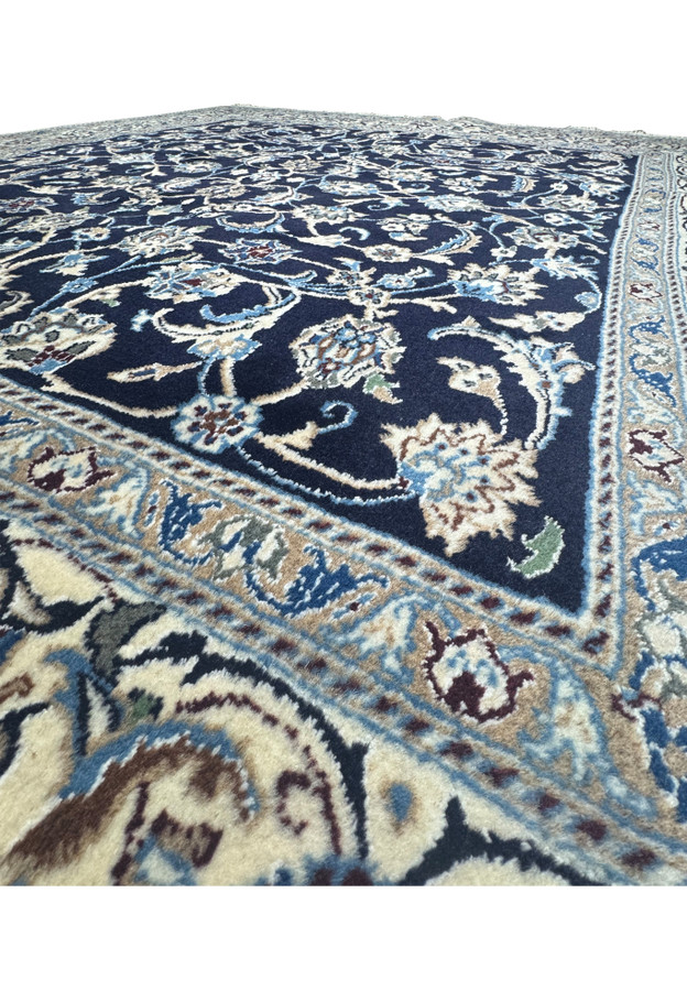 Close-up view of Persian Nain rug field showing crisp knot clarity, soft kork wool texture, and layered floral symmetry