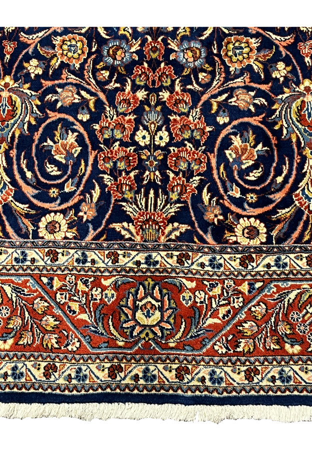 Close-up of red and ivory floral border on Persian Sarough rug