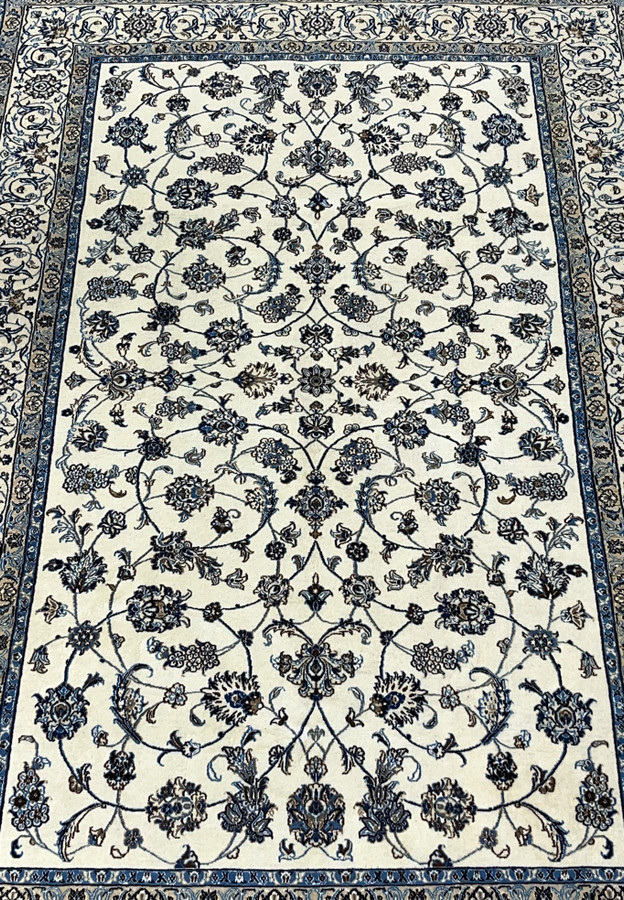 Close view of allover floral field on Persian Nain wool and silk rug