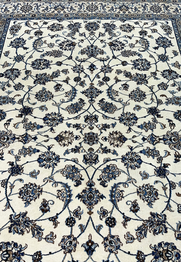 Midfield closeup of Persian Nain rug showing silk highlighted floral rosettes