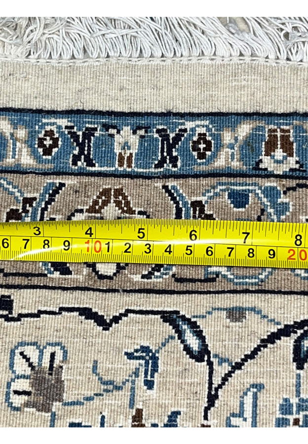 Backside of Persian Nain 9 LA rug with ruler showing knot density, scale, and fine weaving accuracy