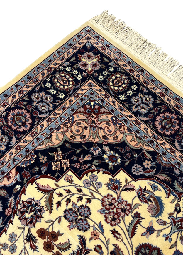 Upper edge of Persian Tabriz rug showing intact fringe and crisp border alignment