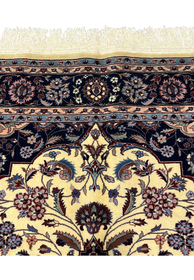 Upper border close-up of Persian Tabriz rug highlighting floral symmetry and color balance