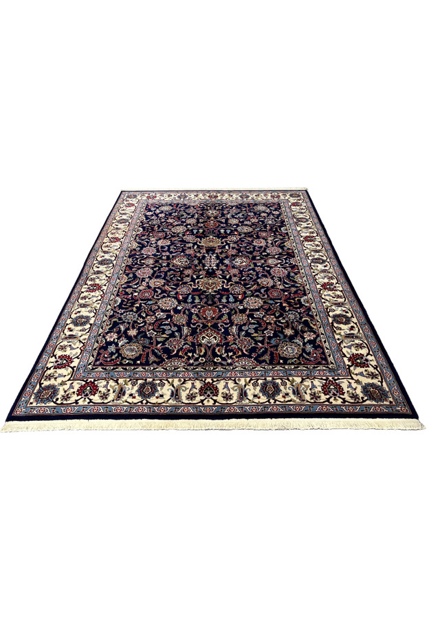 5'7 x 8 Persian Sarough kork rug laid flat showing navy blue field and ivory floral border