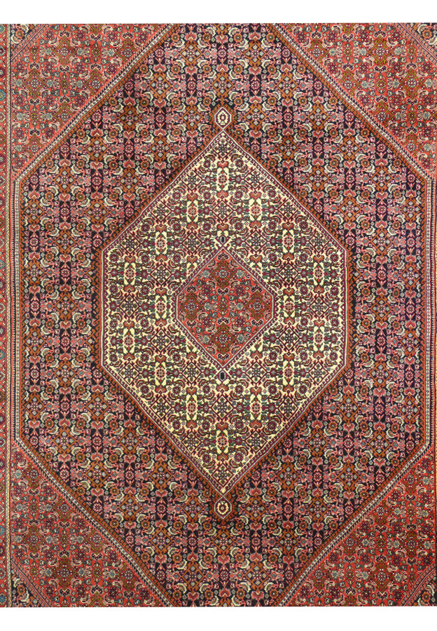 Geometric medallion detail of Persian Bijar rug with deep red and ivory color contrast