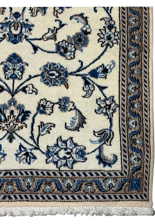 Detailed view of Persian Nain rug border with scrolling vines and blue accents