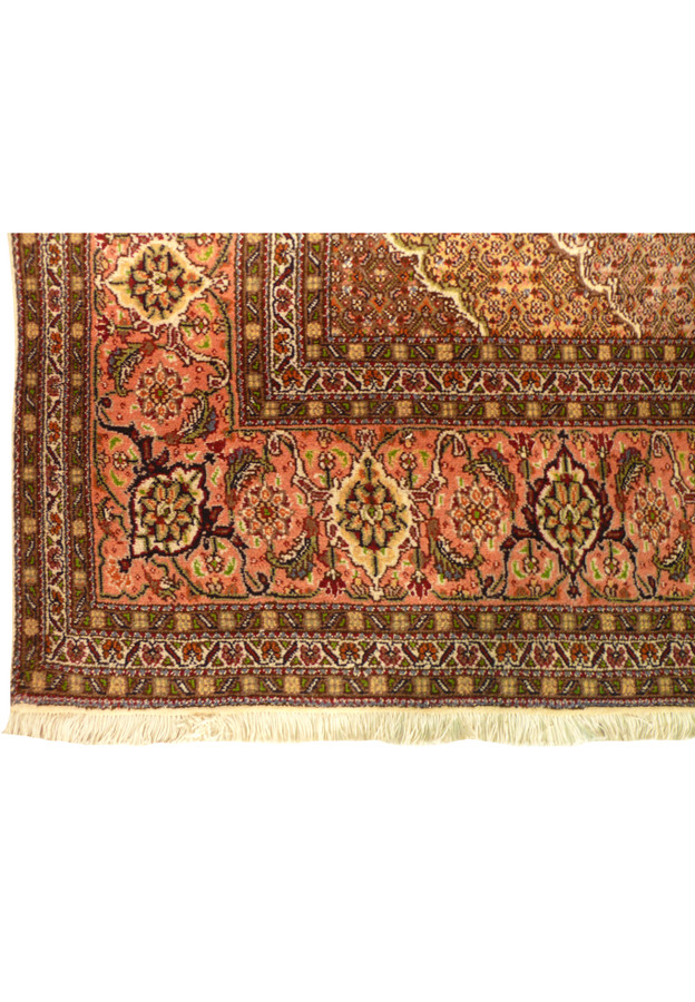 Border detail of Persian Tabriz Mahi rug featuring floral palmettes and warm tones