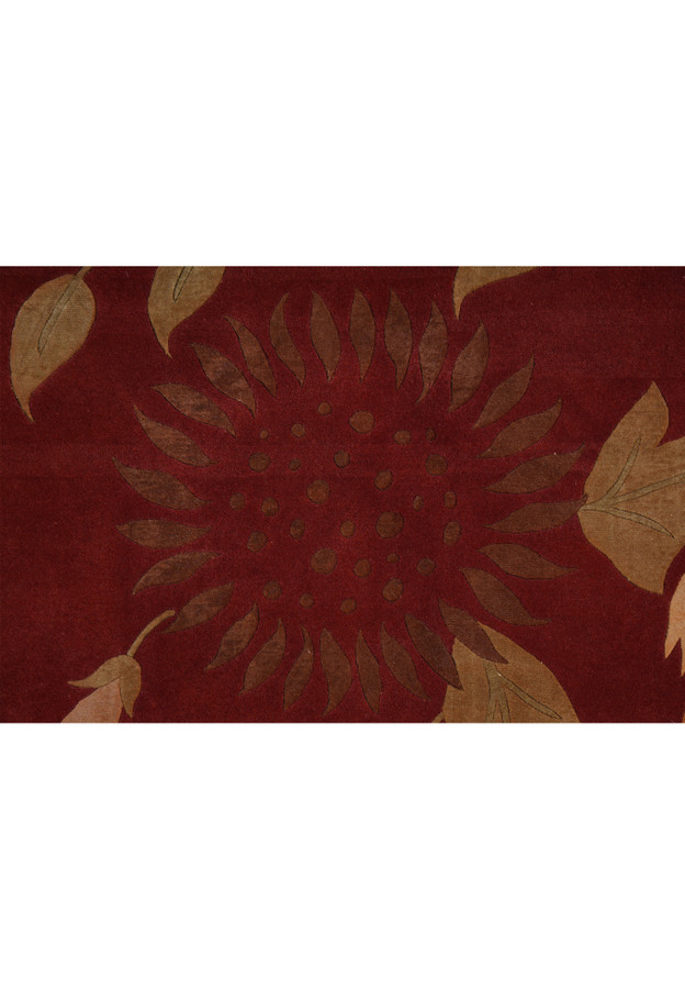 Detailed floral motif close-up on a modern wool and silk Tibetan rug, showing crisp botanical forms and elegant color contrast on a red field