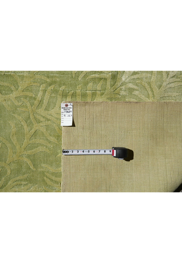 Backside view showing the tightly woven cotton foundation and craftsmanship behind this modern green rug.