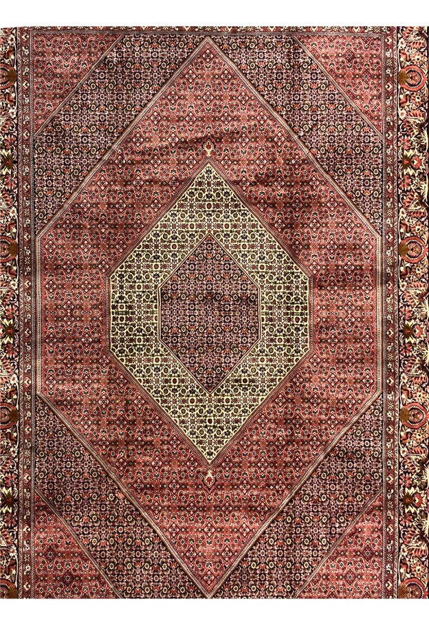 Midfield view of Persian Bijar iron rug with layered red patterns and tightly woven geometric floral motifs