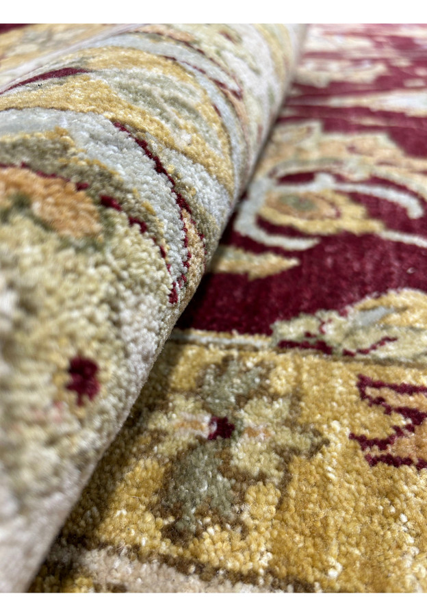 Rolled view highlighting wool texture and color clarity of a Zigler Chobi rug